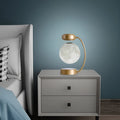 Black and gold magnetic levitation moon lamp floating above base with touch controls