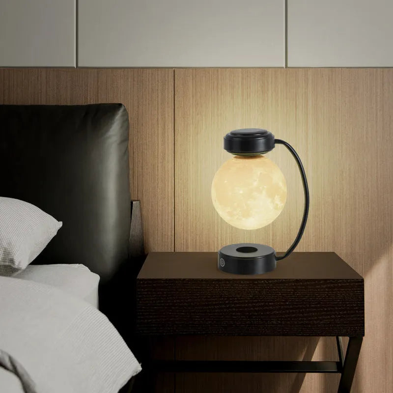 Black and gold magnetic levitation moon lamp floating above base with touch controls