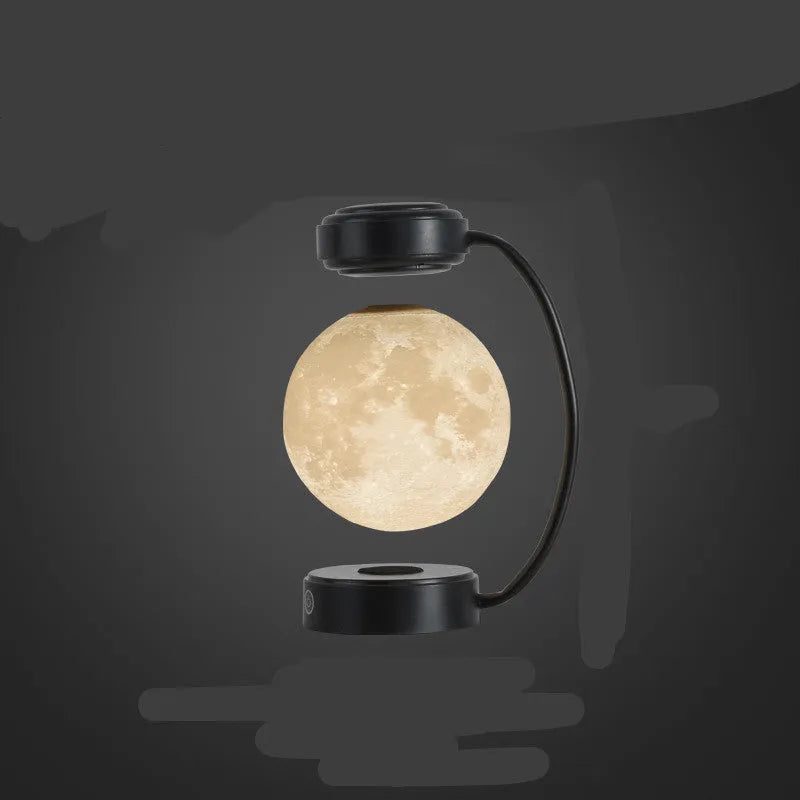 Black and gold magnetic levitation moon lamp floating above base with touch controls