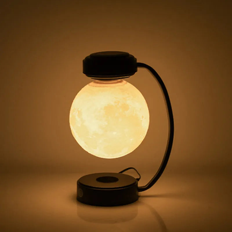 Black and gold magnetic levitation moon lamp floating above base with touch controls
