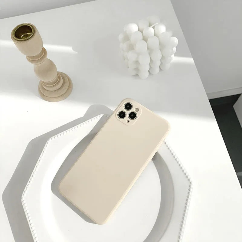 Slim solid colour silicone phone case for iPhone on a flat surface.