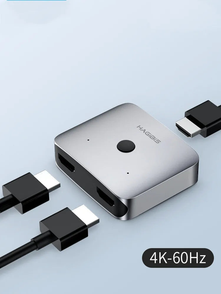 Grey Haibeisi HDMI switcher box showing one input and two output ports for splitting a video signal to two screens.