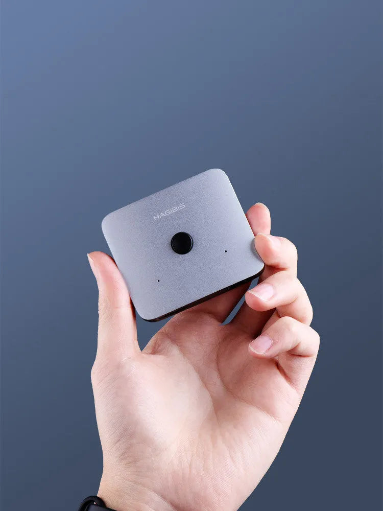 Grey Haibeisi HDMI switcher box showing one input and two output ports for splitting a video signal to two screens.