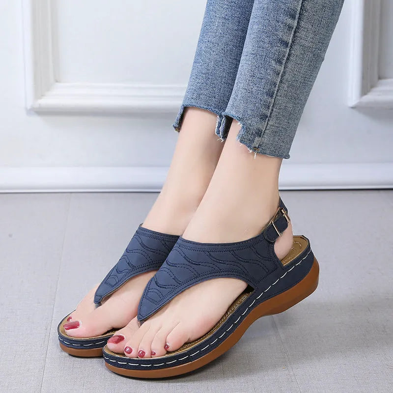 Women's casual wedge heel flip flop sandals with an adjustable buckle strap in a solid colour.