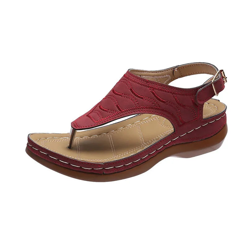 Women's casual wedge heel flip flop sandals with an adjustable buckle strap in a solid colour.