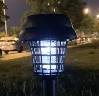 Small white and purple solar-powered mosquito killer lamp for outdoor garden use.