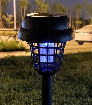 Small white and purple solar-powered mosquito killer lamp for outdoor garden use.
