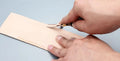 Leather hand tools kit with sectional cutting knife and wide shovel edge thinner for skiving.