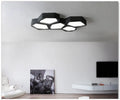 Geometric shaped LED wall or ceiling light in black or white iron frame with remote control.