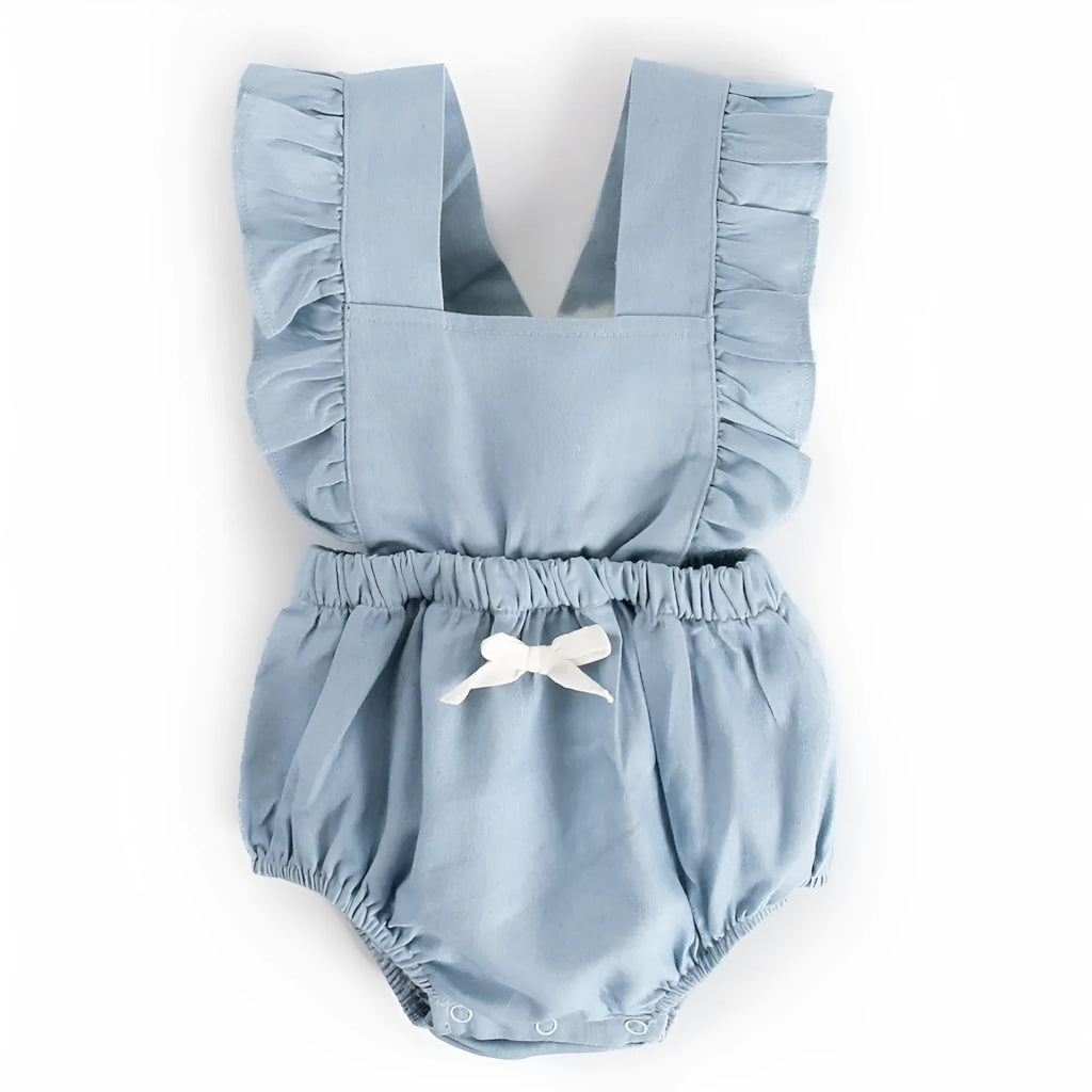 Blue denim sleeveless baby romper with lace trim on a hanger