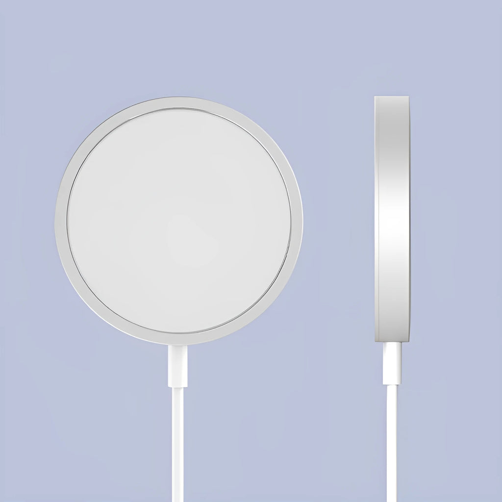 Silver metal Magsafe wireless charger for iPhone on a wooden surface.