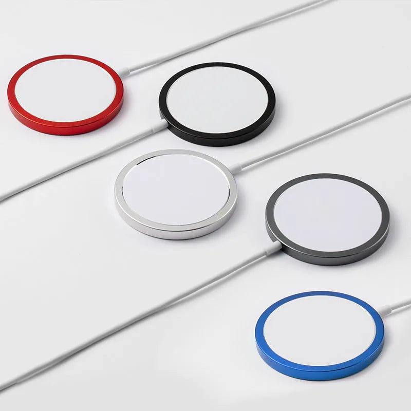 Silver metal Magsafe wireless charger for iPhone on a wooden surface.