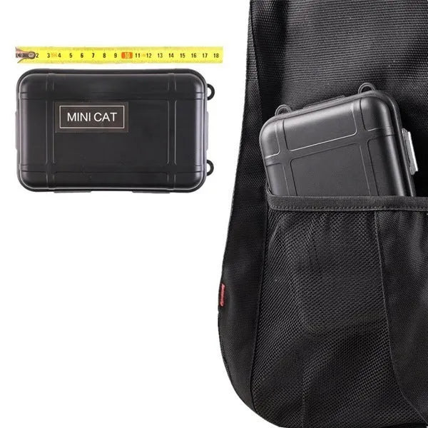 Black outdoor survival kit open to show compass, flashlight, wire saw, and tools inside a shockproof case.