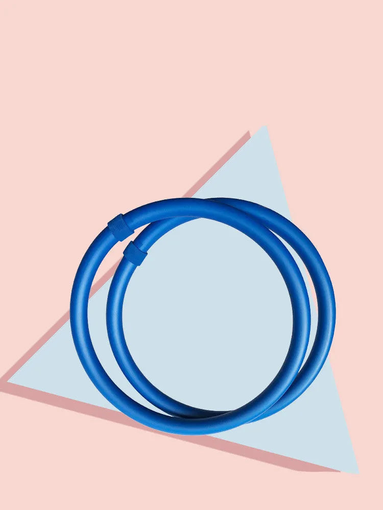 Blue arm hoop massage and exercise equipment with soft foam outer layer on a white background