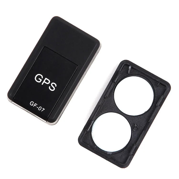 Small black plastic magnetic GPS car tracker device with USB cable.