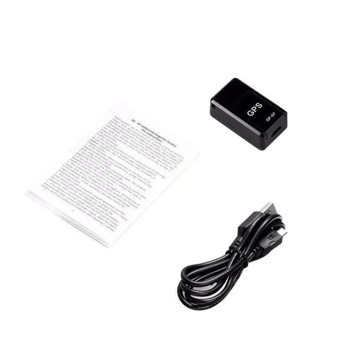 Small black plastic magnetic GPS car tracker device with USB cable.