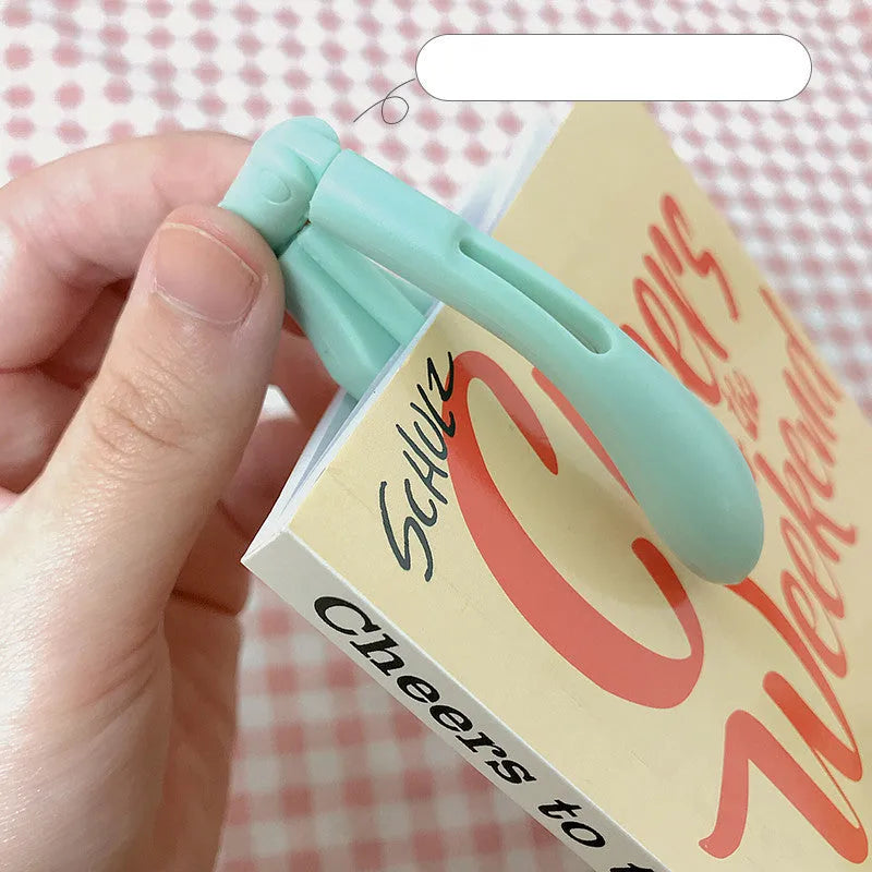 Folding book light in four colour options: yellow, green, blue, and pink with button switch control