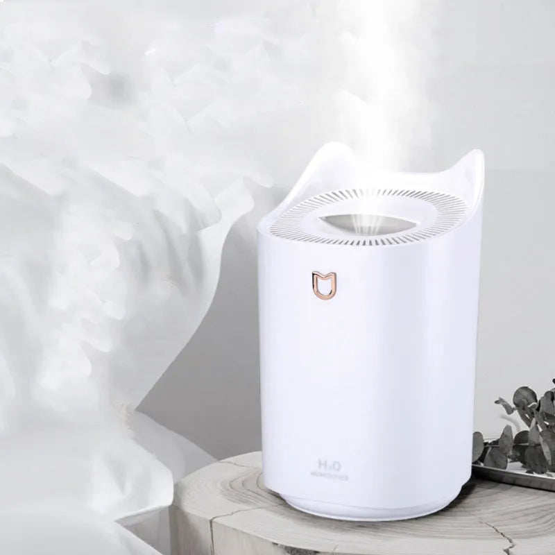 Coral Pink USB-powered humidifier and aroma diffuser with three mist outlets on a wooden table.