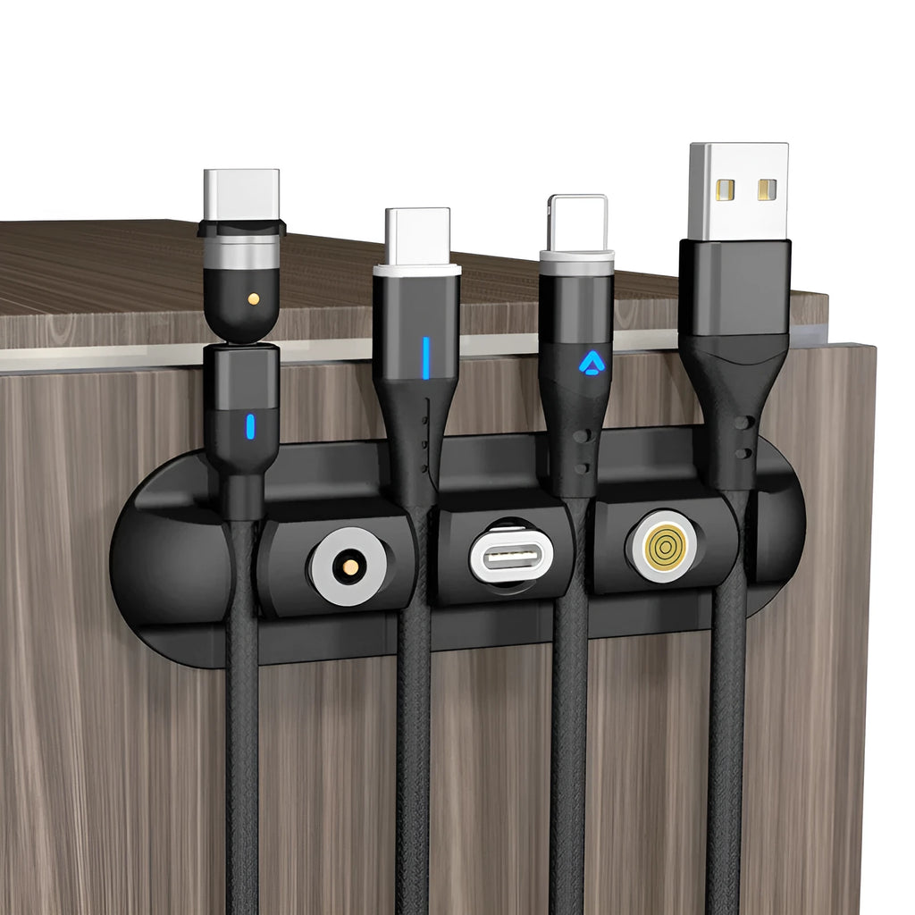 Black magnetic desktop charging cable organiser with soft plastic construction for cable storage