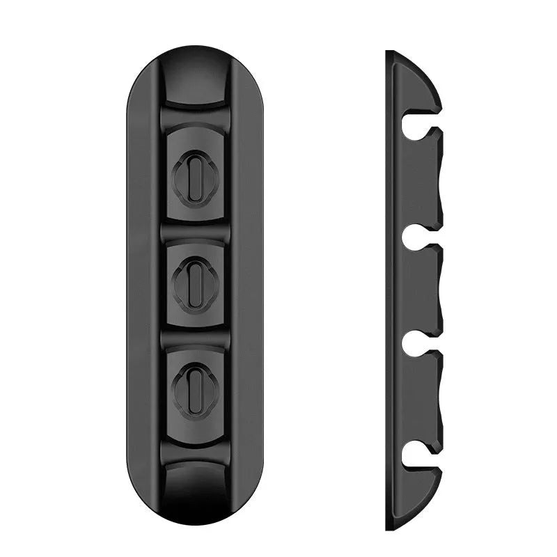 Black magnetic desktop charging cable organiser with soft plastic construction for cable storage