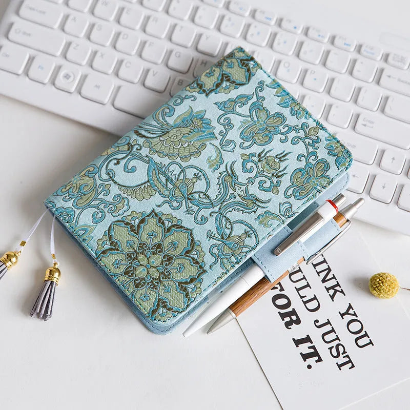 Flying Blue Flower fabric notebook in A5 and A6 sizes on a table.