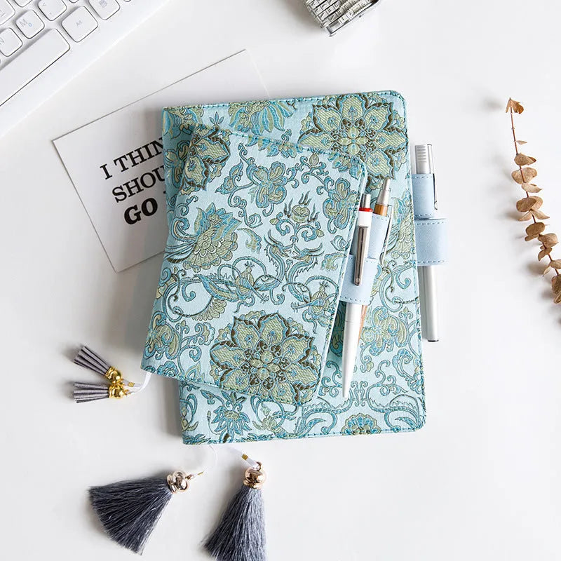 Flying Blue Flower fabric notebook in A5 and A6 sizes on a table.