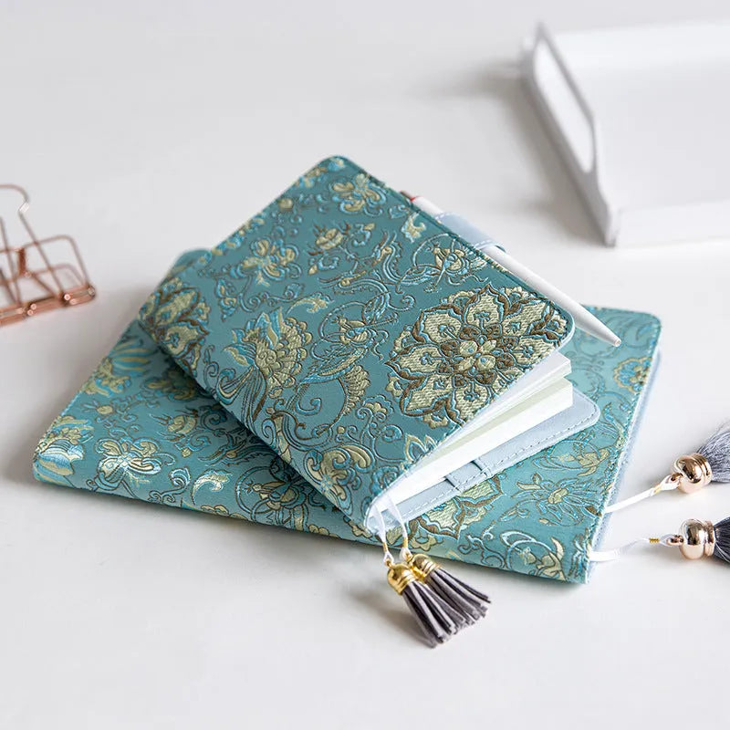 Flying Blue Flower fabric notebook in A5 and A6 sizes on a table.