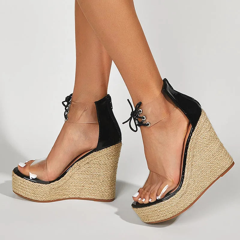 Black women's wedge sandals with hemp rope detail on high platform heel and front tie closure.