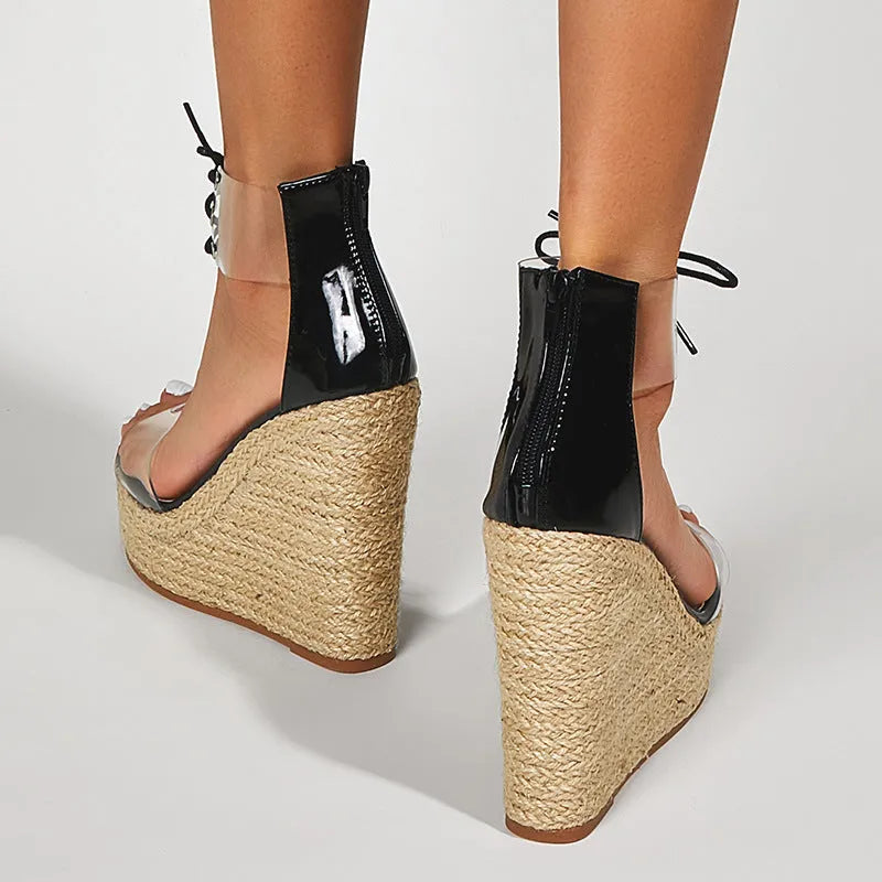 Black women's wedge sandals with hemp rope detail on high platform heel and front tie closure.