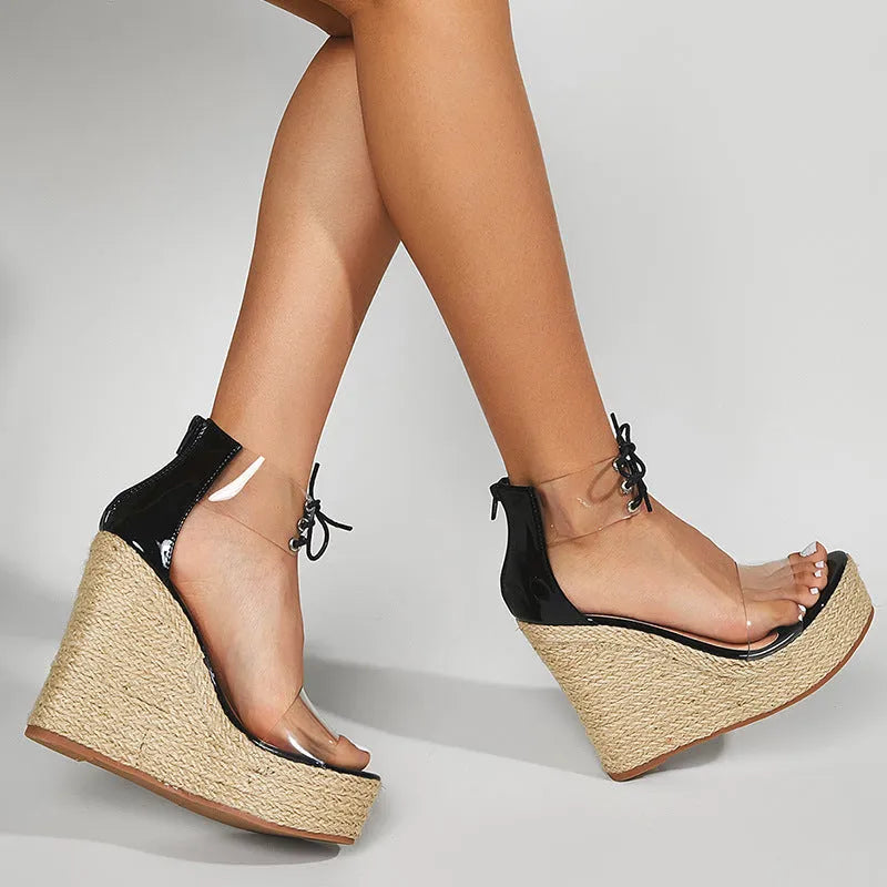 Black women's wedge sandals with hemp rope detail on high platform heel and front tie closure.