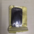 Folding double ring metal phone holder in silver with square buckle, open on a desk holding a smartphone