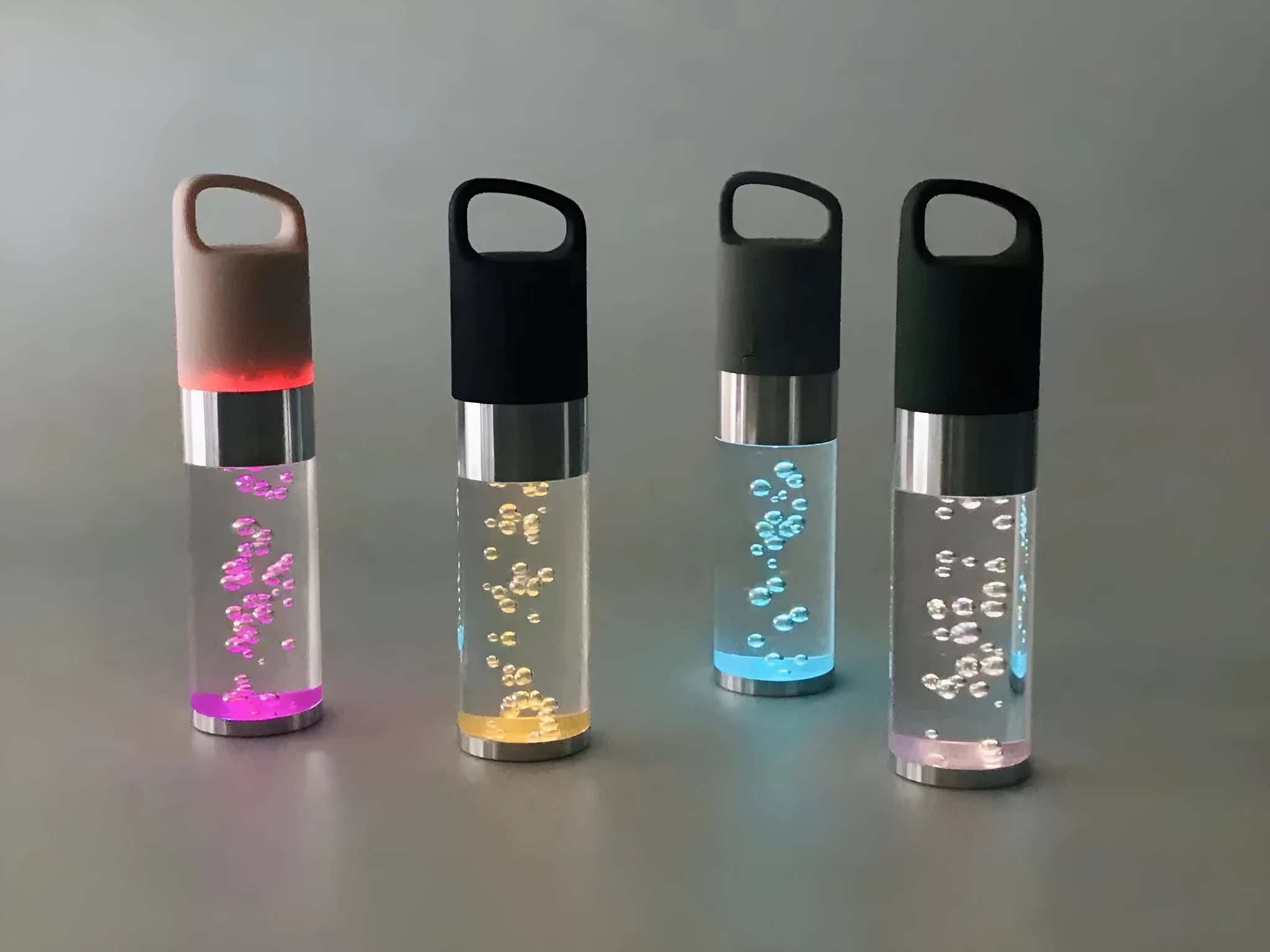 Small colourful Bluetooth speaker with decorative crystal light in pink, black, silver, or green.