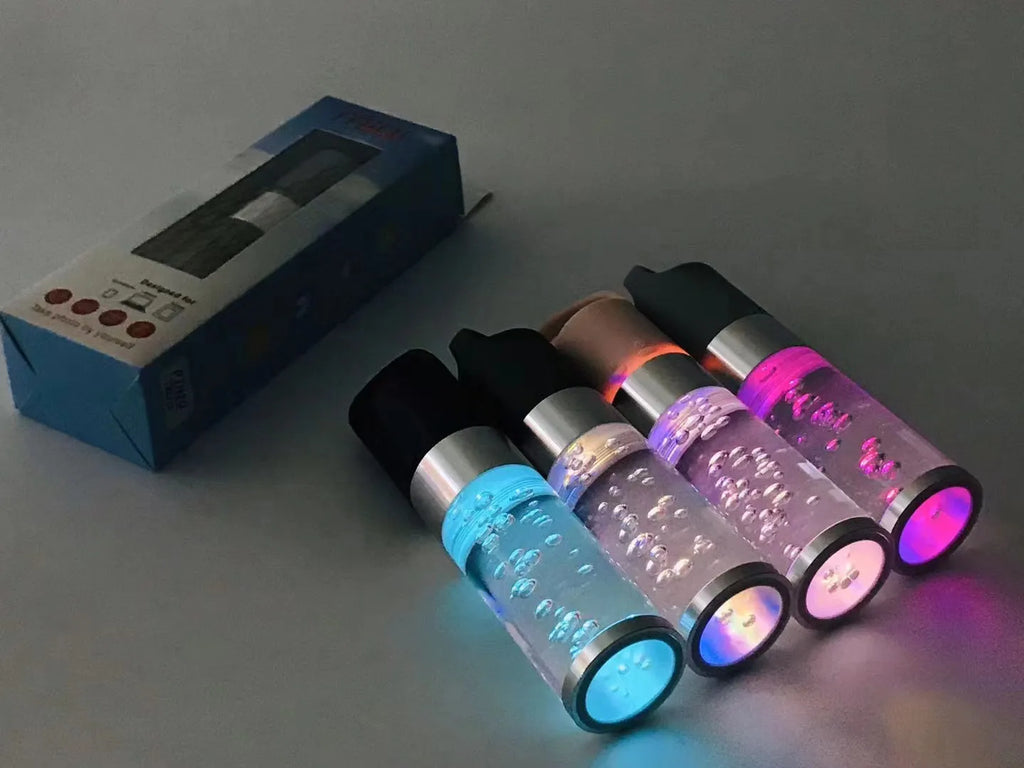 Small colourful Bluetooth speaker with decorative crystal light in pink, black, silver, or green.