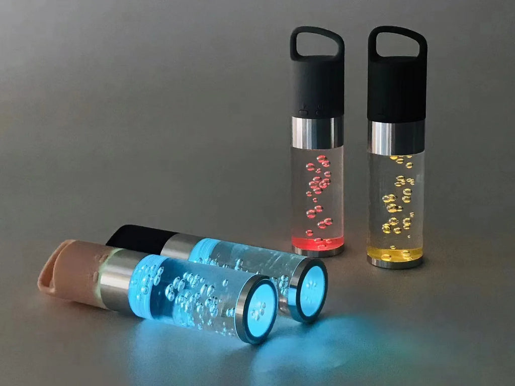 Small colourful Bluetooth speaker with decorative crystal light in pink, black, silver, or green.