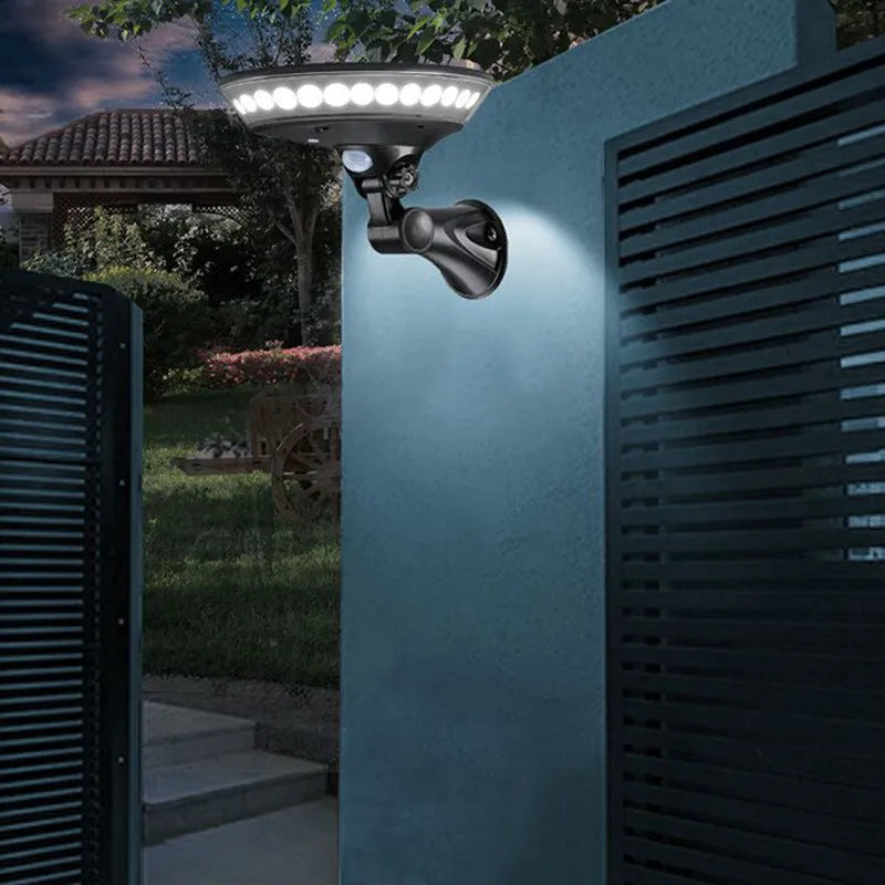White 360-degree solar-powered security light with motion sensor, mounted on a wall.