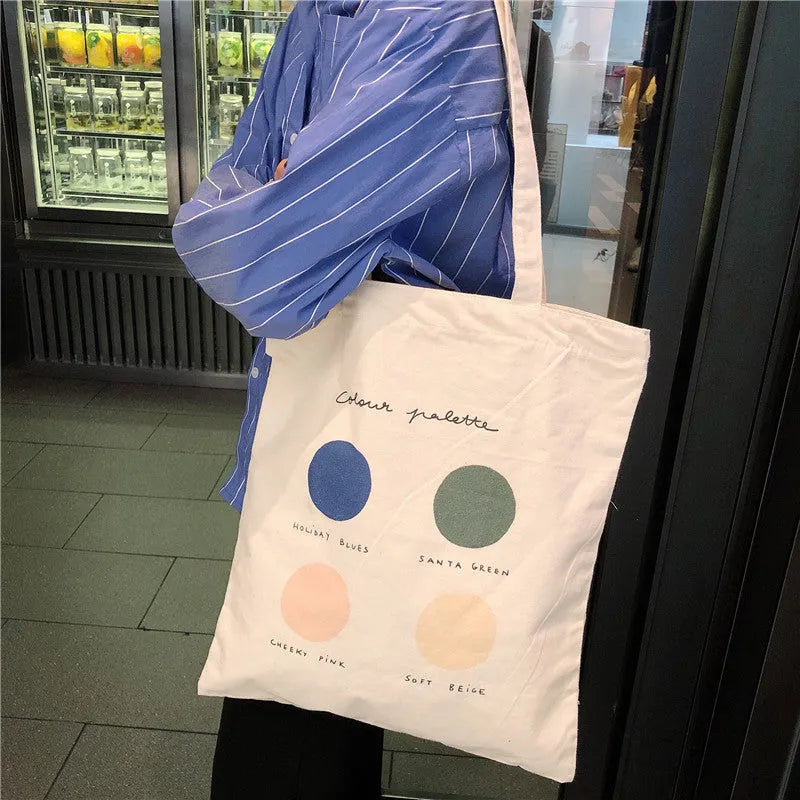 Women's medium canvas tote bag with zip closure and geometric pattern in light pink or orange