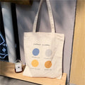 Women's medium canvas tote bag with zip closure and geometric pattern in light pink or orange