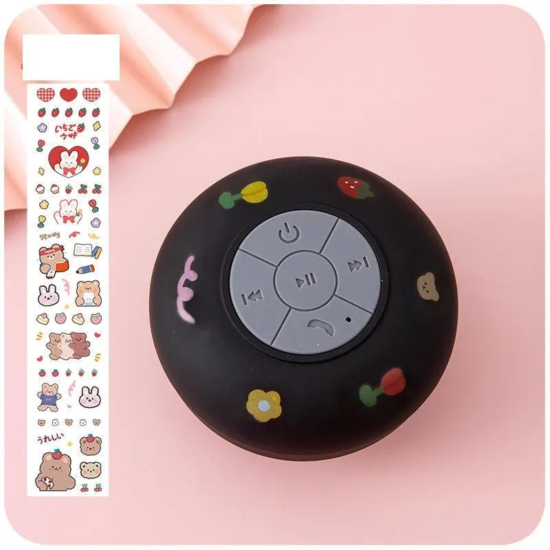 Small waterproof Bluetooth speaker with silicone suction cup base in five colour options
