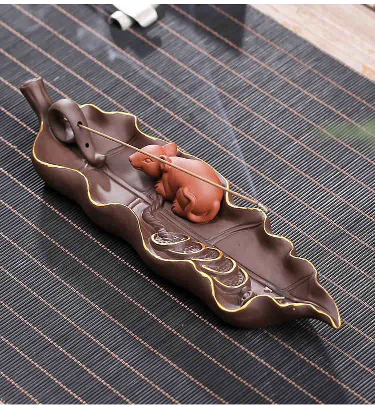 Dehua purple clay ceramic lying incense burner with gold rat design, 17 cm length