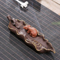 Dehua purple clay ceramic lying incense burner with gold rat design, 17 cm length