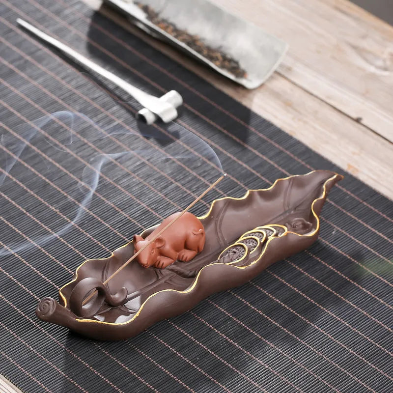 Dehua purple clay ceramic lying incense burner with gold rat design, 17 cm length