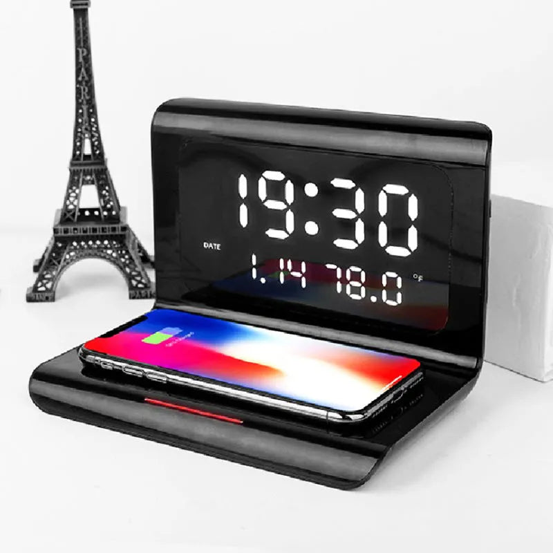 White wireless charger alarm clock showing time, calendar, temperature display with phone charging