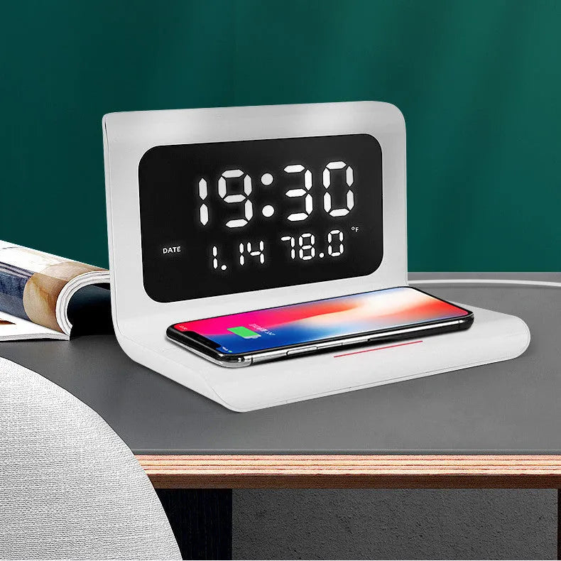 White wireless charger alarm clock showing time, calendar, temperature display with phone charging