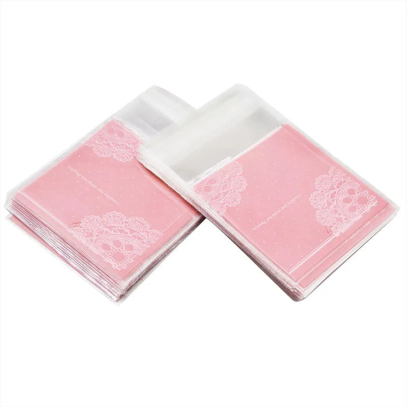 Pink self-adhesive plastic packaging bags with UV printing, shown in a pack of 100.