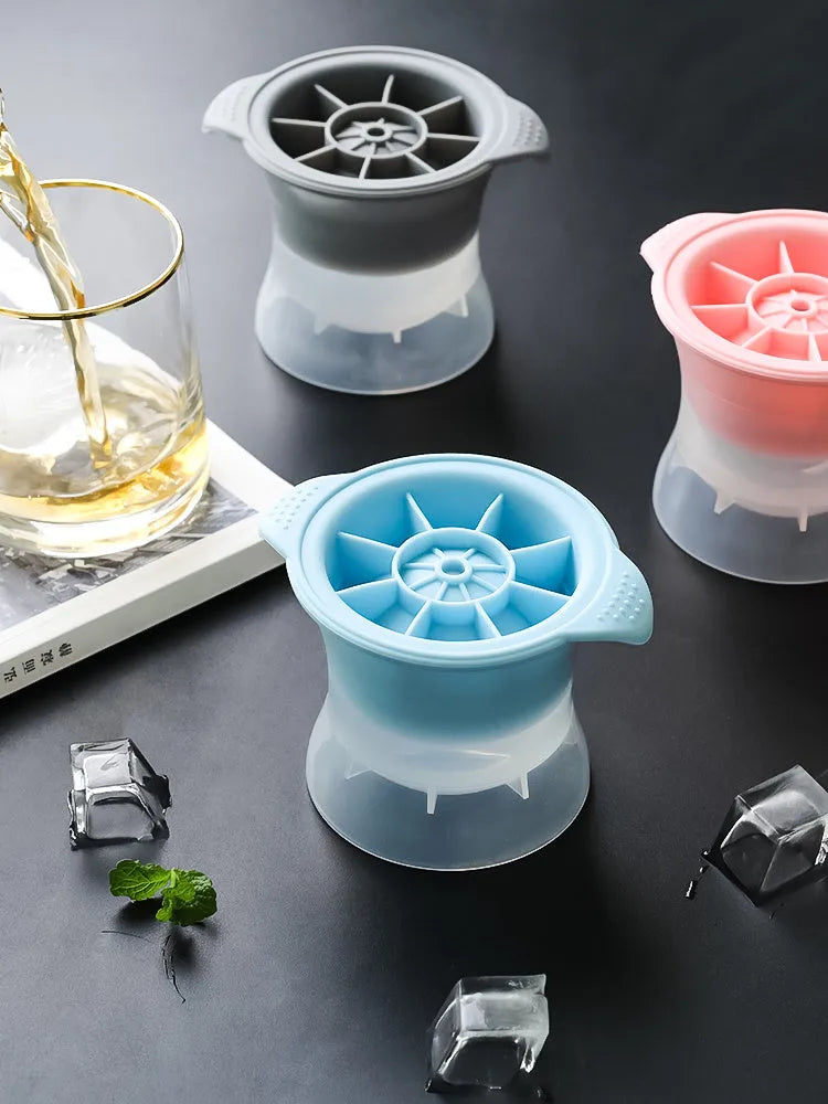 Flexible silicone ice tray making large hockey puck and round geometric ice cubes in assorted colours.