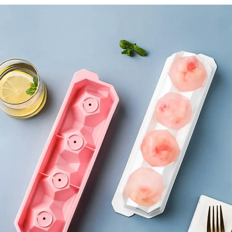Flexible silicone ice tray making large hockey puck and round geometric ice cubes in assorted colours.