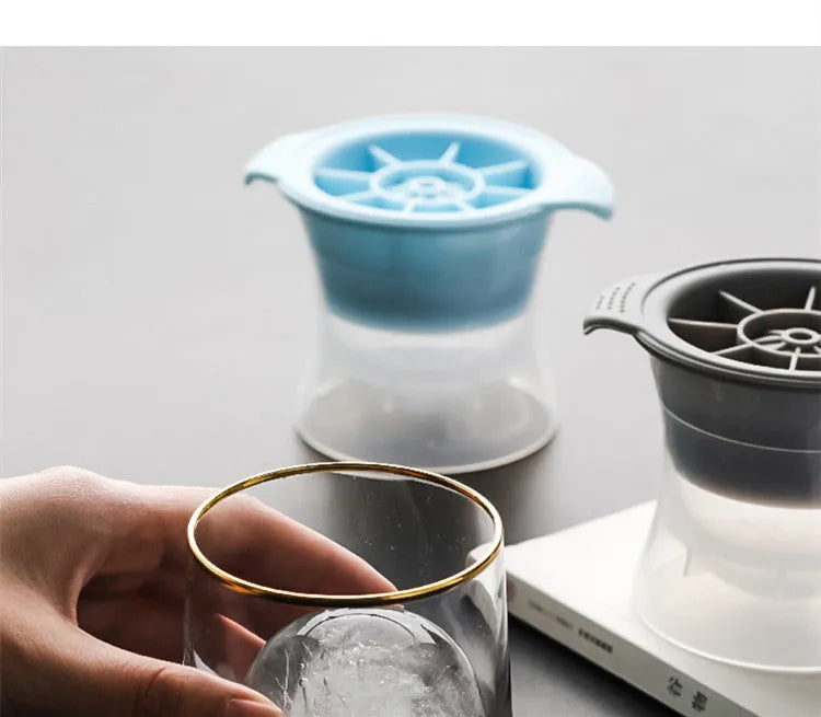 Flexible silicone ice tray making large hockey puck and round geometric ice cubes in assorted colours.