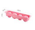 Flexible silicone ice tray making large hockey puck and round geometric ice cubes in assorted colours.