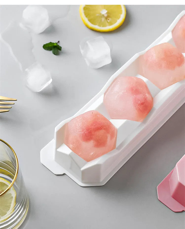 Flexible silicone ice tray making large hockey puck and round geometric ice cubes in assorted colours.