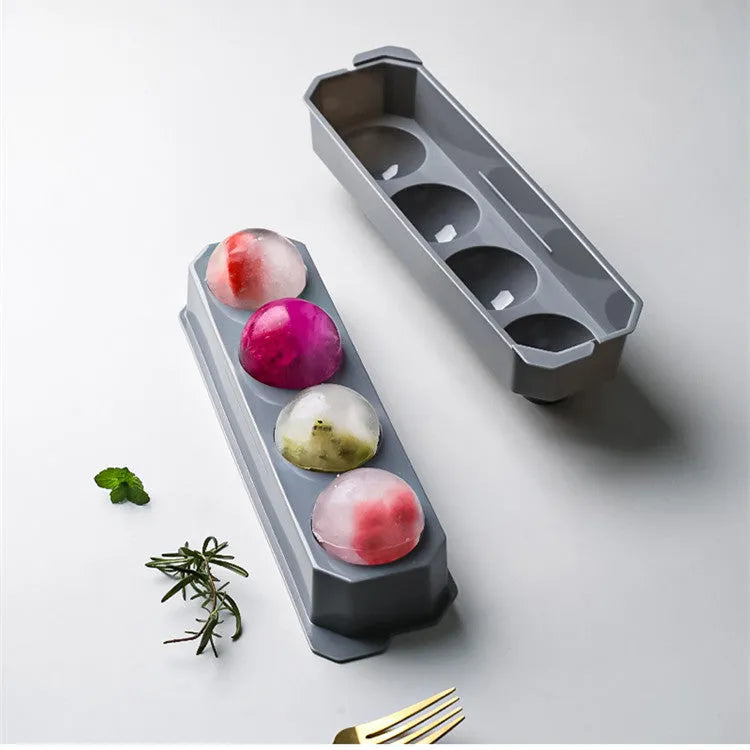 Flexible silicone ice tray making large hockey puck and round geometric ice cubes in assorted colours.